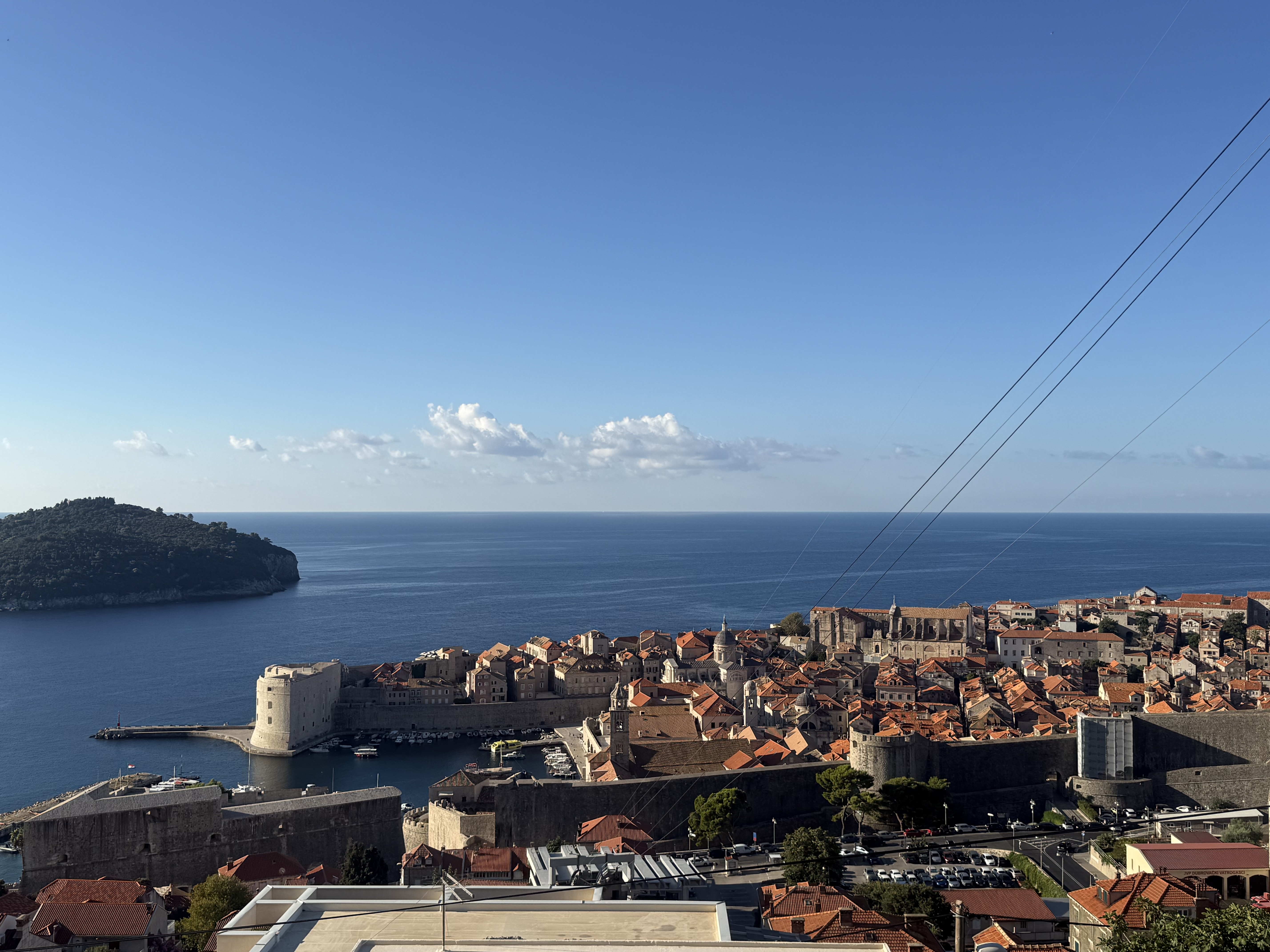 View over Dubrovnik's terracotta rooftops and city walls to Lokrum island and the Adriatic Sea